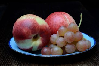 Nectarines and table grapes on plate