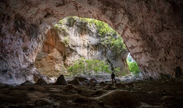 Hiker stands in the cave Cueva de La Ermita