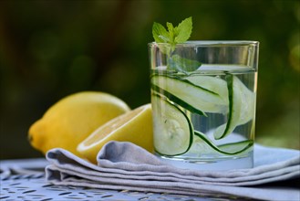 Cucumber water in glass and lemons