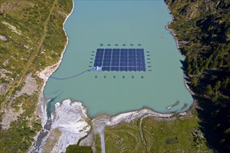 Solar collectors of a solar power plant floating on the mountain lake Lac des Toules