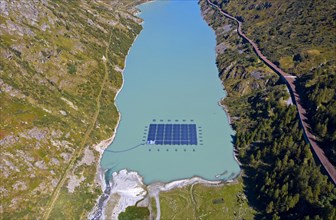 Solar collectors of a solar power plant floating on the mountain lake Lac des Toules