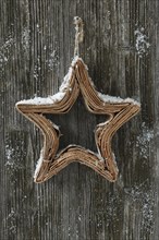 Star of wooden bark on wooden door