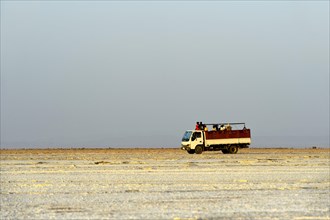 Truck drives with workers from the salt mine across the Assale Salt Lake to Hamadela