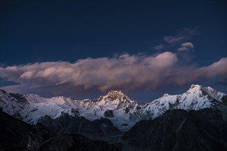 View in the evening light from Renjo La Pass 5417m to the east on Himalaya with Gyachung Kang 7952m