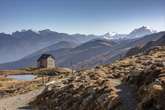 Mountain hut Sesvenna in front of an alpine panorama with Ortler