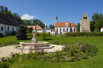 Monastery church with Roman tower and fountain with fountain figure of abbot Walto or Balto