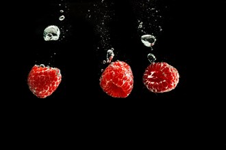 Raspberries fall into water