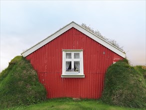 Traditional peat house Lindarbakki with red gable wall