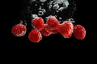 Raspberries fall into water