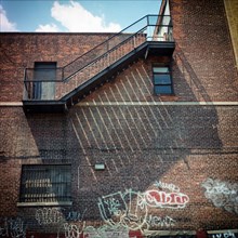 Fire wall and fire escape at noon light