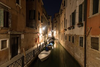 Small channel with boats at night