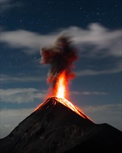 Glowing lava and smoke spitting volcano