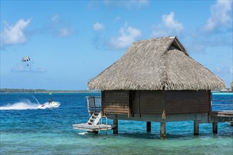 Water sports and overwater bungalow in the lagoon
