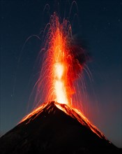 Glowing lava and smoke spitting volcano