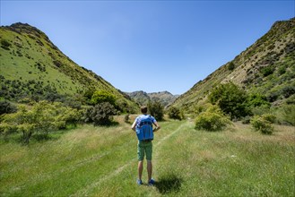 Hiker on trail in a valley