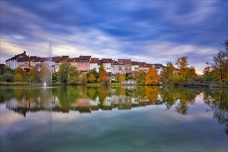 Reflection of the old town of Wil in the pond of the municipal park