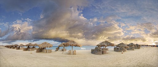 Sandy beach beach with umbrellas at the coral reef Abu-Dabbab
