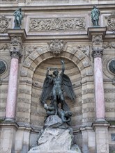 Bronze statue of the fountain La Fontaine Saint Michel at Place Saint-Michel