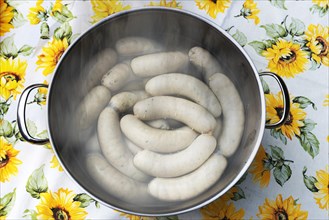 White sausages in a pot of hot water