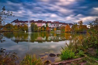 Reflection of the old town of Wil in the pond of the municipal park