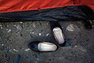 Girls' shoes in front of a tent
