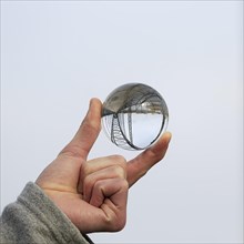 Hand holding glass ball