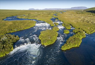 Aerial view of small green grass-covered islands in the river Laxa i Aoaldal