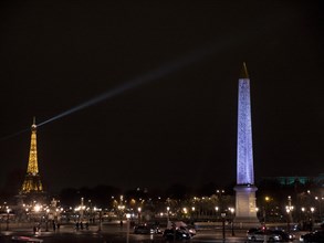 Night view of the illuminated obelisk of Luxor and the Eiffel Tower