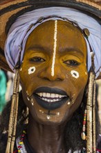 Wodaabe-Bororo man with faces painted at the annual Gerewol festival