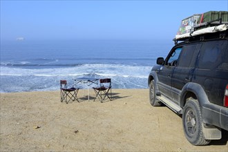 Camping furniture and off-road vehicles at Supay Beach