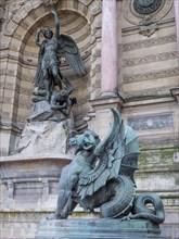 Bronze statue of the fountain La Fontaine Saint Michel at Place Saint-Michel