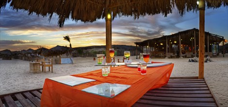 Beach bar with different cocktails at sunset at the coral reef Abu-Dabbab