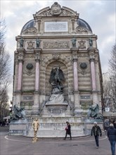 Bronze statue of the fountain La Fontaine Saint Michel at Place Saint-Michel