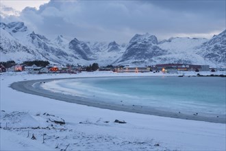 Snowy landscape at sea bay with sandy beach