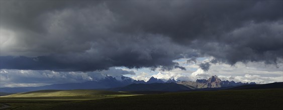 Mountain range of the Cordillera Blanca under dark clouds