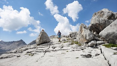 Hikers in a landscape of washed out karst rocks