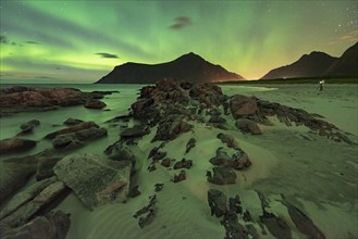 Northern lights over rocky beach