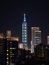 Illuminated Taipei 101 Tower with skyscrapers at night