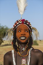 Wodaabe-Bororo man with his face painted at the annual Gerewol festival