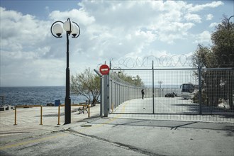 Refugees on a cordoned-off site in Mytilene