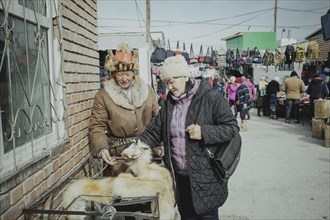Eagle hunter Bashakhan Spai at the bazaar selling his fox furs