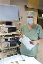 Nurse with respirator in operating theatre