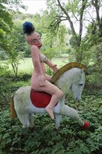 Naked Amazon riding a horse