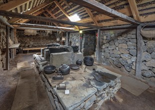 Interior view of pots and pans on an old fireplace in the back Hides on peat farm
