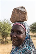 Woman with a stone on her head