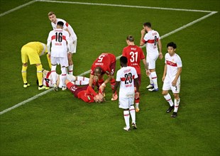 Marc-Oliver Kempf VfB Stuttgart and Sebastian Bornauw 1st FC Koeln injured on the ground Mercedes-Benz Arena