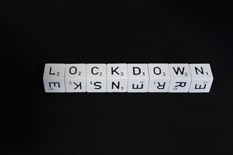 Letter cubes in a row form the word Lockdown