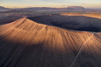 Aerial view of the tuffring crater Hverfjall in the evening light in the Krafla volcano system in the Myvatn region rising from the green plain