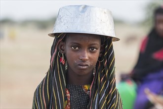 Young girl with a a water pot on her head