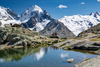 Small mountain lake on Fuorcla Surlej with Piz Roseg and Piz Glueschaint